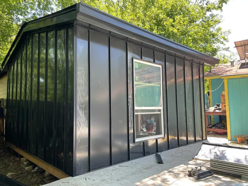 Black standing seam metal wall panels for Roof Inspection in McKinney