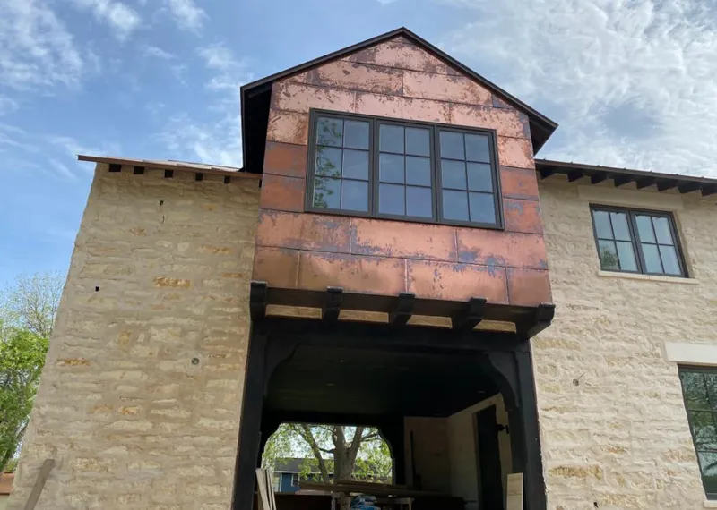 Copper metal panel facade on a stone building for Metal Roof Coating in McKinney