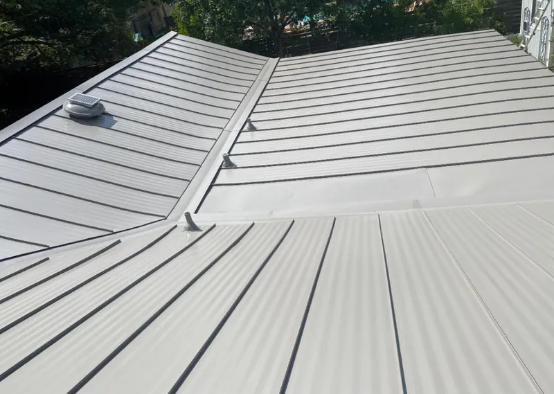 Solar attic fan installed on a metal roof for Roof Ventilation in McKinney
